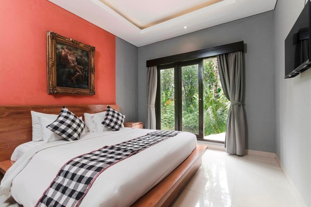 Postel nebo postele na pokoji v ubytování Nawa Sakti Ubud Suite
