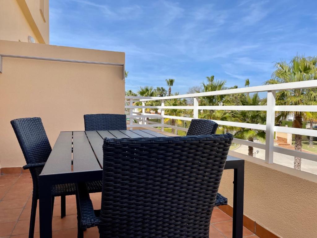 a table and chairs on a balcony with a view at Par 3 Oliva Nova in Oliva