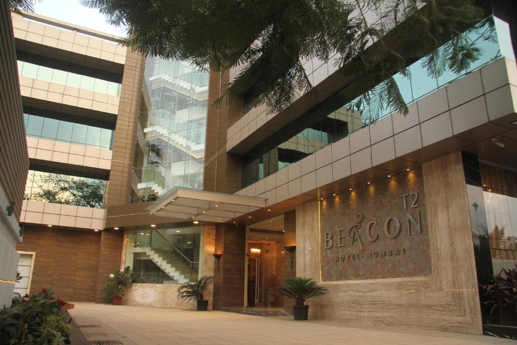 un gran edificio con un cartel que lee comenzó en Hotel Beacon T2, en Bombay
