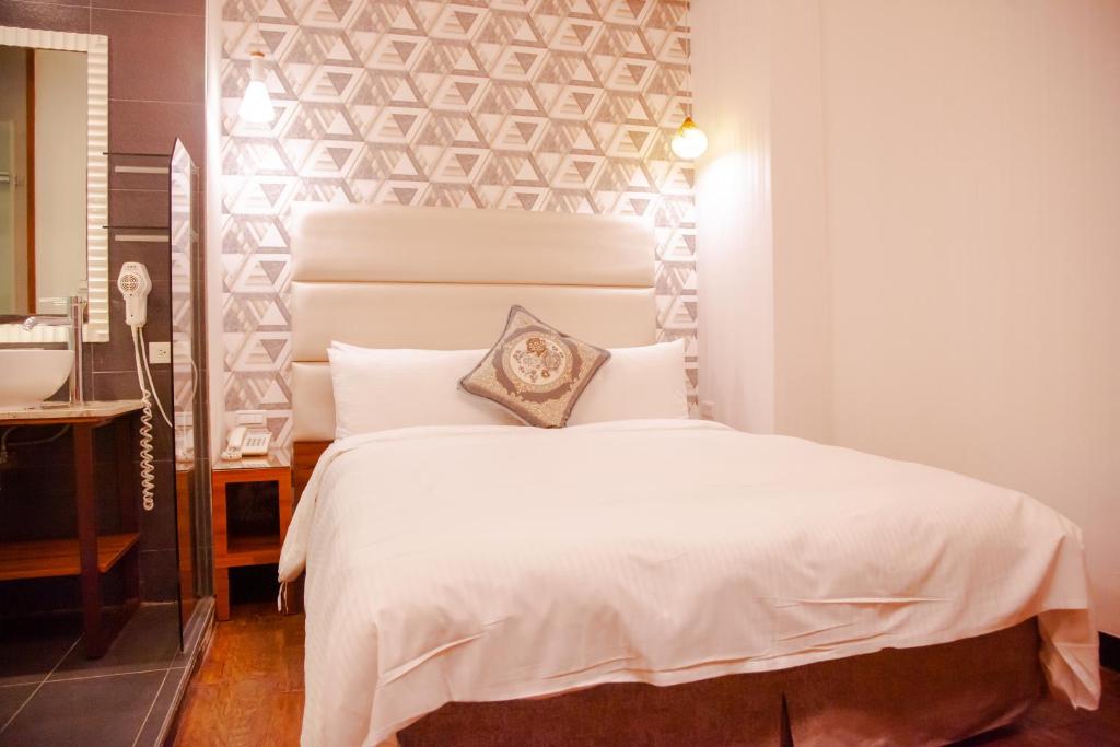 Postel nebo postele na pokoji v ubytování E-Coast Star Hotel