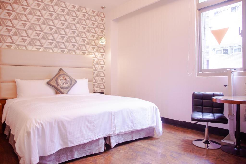 Postel nebo postele na pokoji v ubytování E-Coast Star Hotel