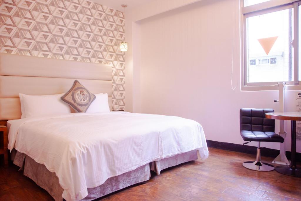 Postel nebo postele na pokoji v ubytování E-Coast Star Hotel