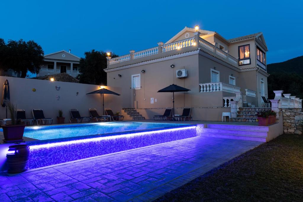 a villa with a swimming pool at night at Villa Clearvue 