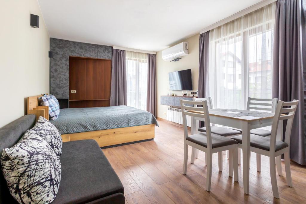 a bedroom with a bed and a table and chairs at View apartment #1 in Bansko