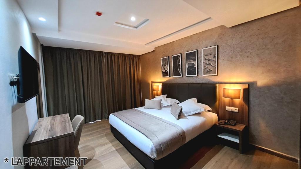 Postel nebo postele na pokoji v ubytování Hotel Jaouharat Ismaili