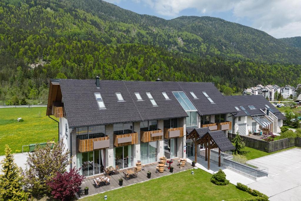 an aerial view of a house with mountains in the background at Boutique Skipass Superior Hotel in Kranjska Gora