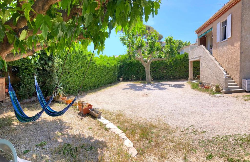 a yard with two hammocks and a house at Blue Summer Vibes Duplex Studio for 4P, AC, sea view, parking, beach at 50m, SPA access -3 in La Ciotat
