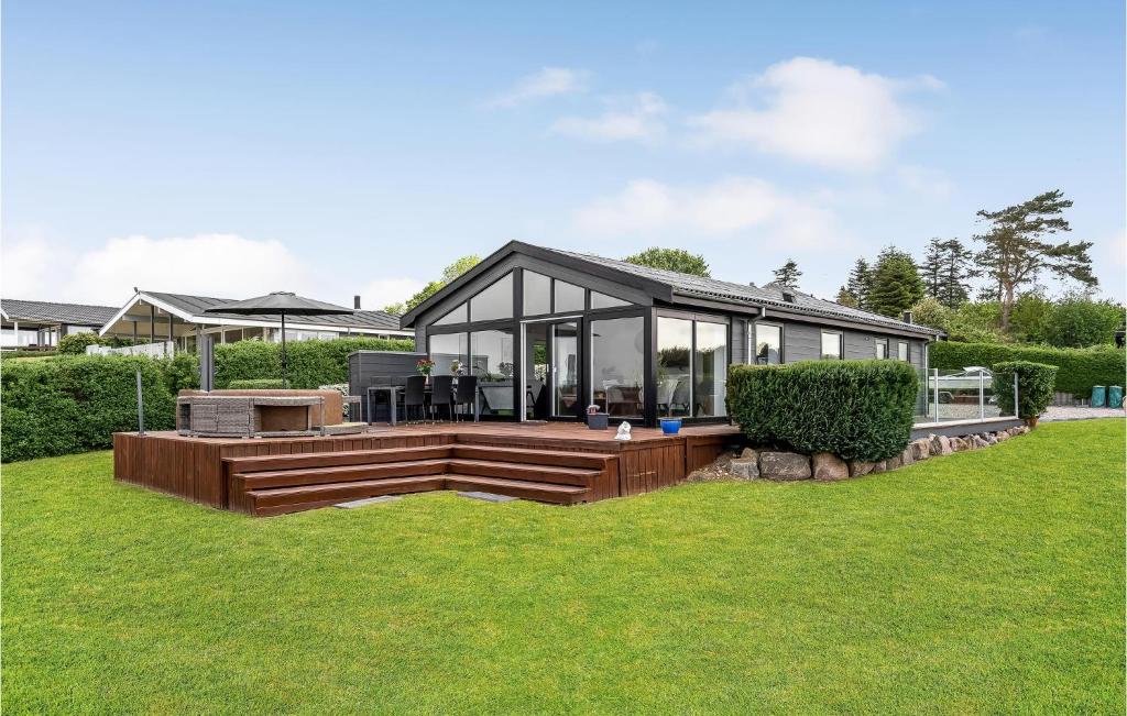 a modern house with a deck and glass at Beautiful Home In Faaborg With Jacuzzi in Fåborg