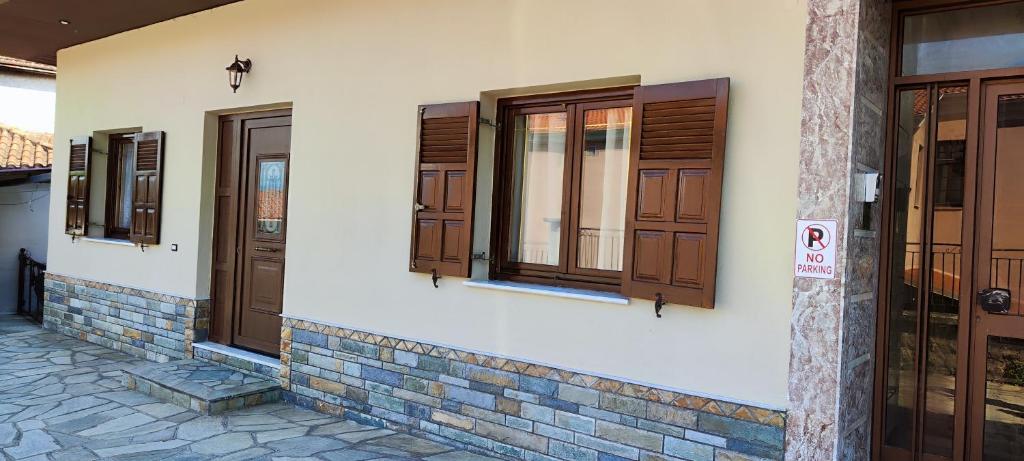 a group of doors and windows on a building at Theofania's Marble House Meteora in Kastraki