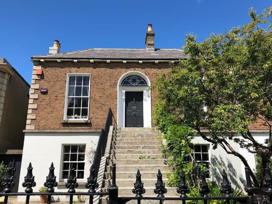 a brick house with stairs leading up to a door at Family home in the heart of Dublin in Dublin