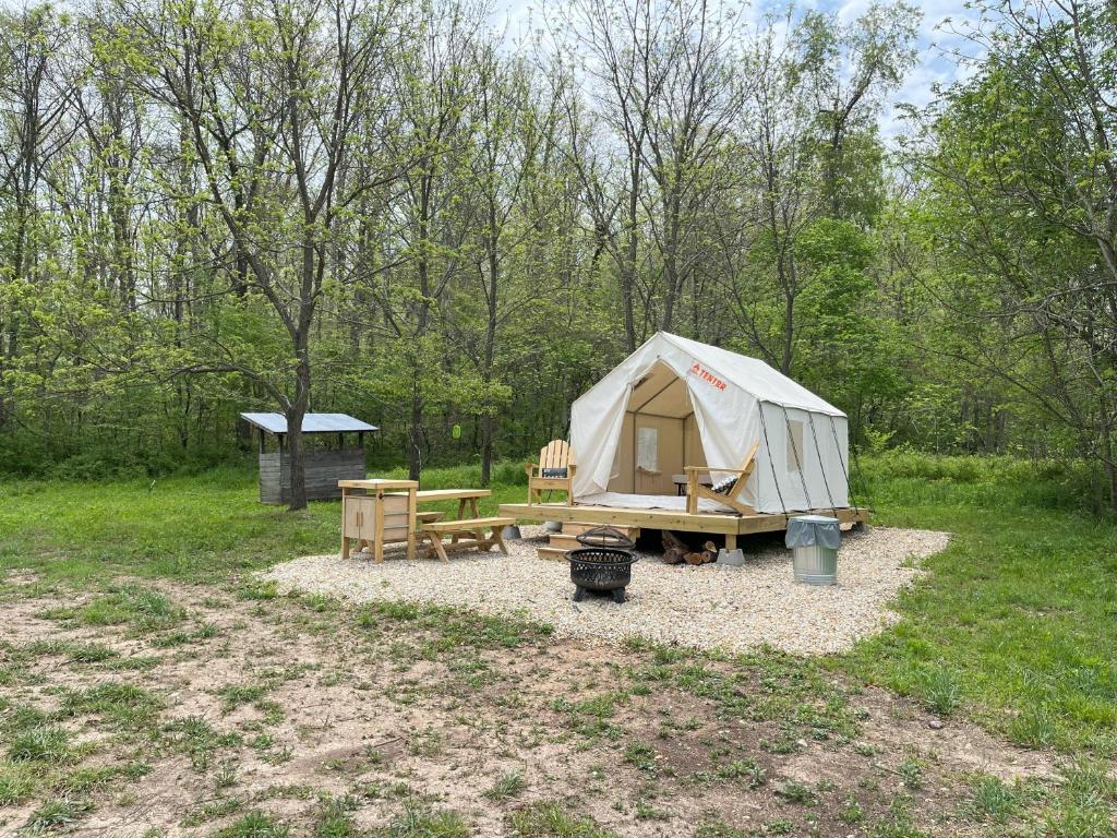 a tent and a picnic table and a grill at Tentrr Signature Site - Maramec Spring Park McDole's Meadow in Saint James