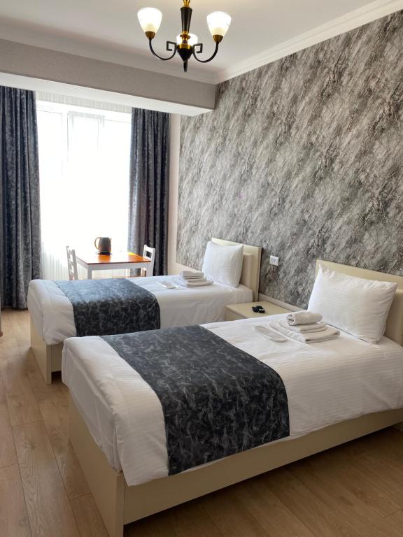 Postel nebo postele na pokoji v ubytování Hotel Sharl