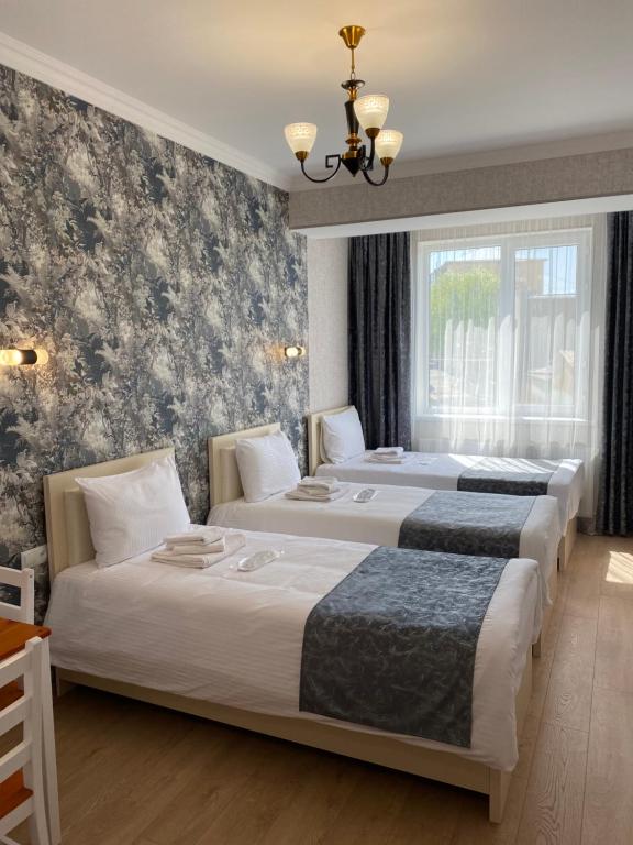 Postel nebo postele na pokoji v ubytování Hotel Sharl