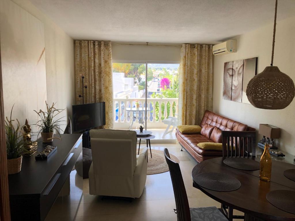 a living room with a couch and a table at Apartment RoSol Albir Playa in Albir