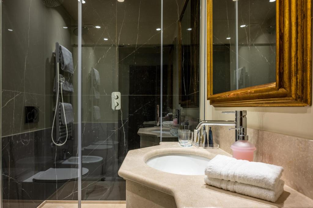 a bathroom with a sink and a shower at Palazzo Bembo - Exclusive Accommodation in Venice