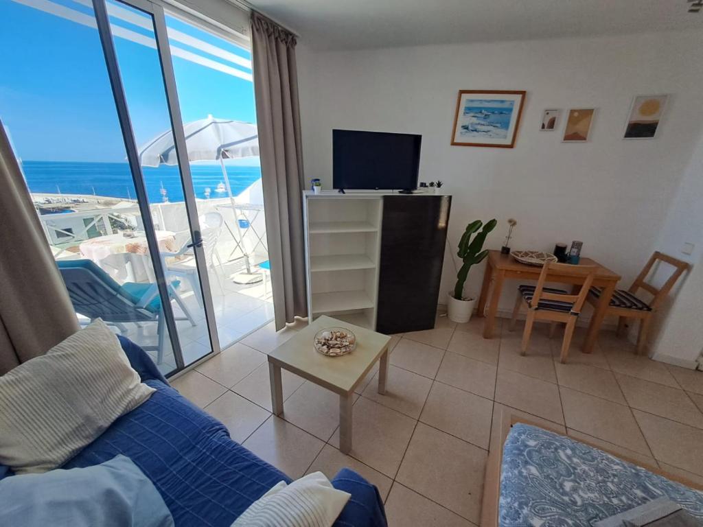 a living room with a view of the ocean at Comfortable Lucy apartment with amazing sea-view in Puerto del Carmen