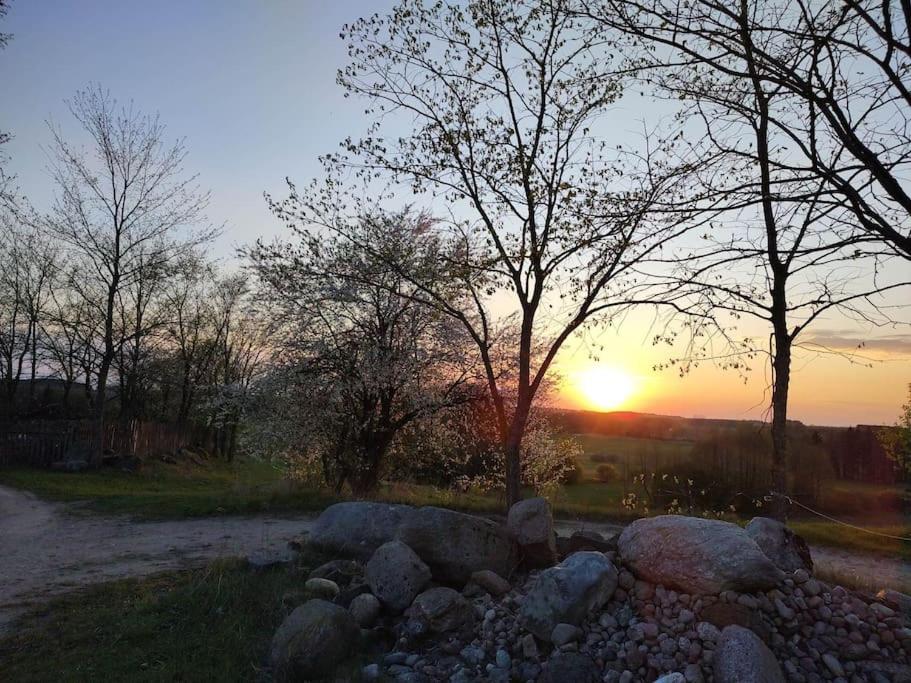 a pile of rocks in front of a sunset at Siedlisko Magiczne Cimanie in Cimanie
