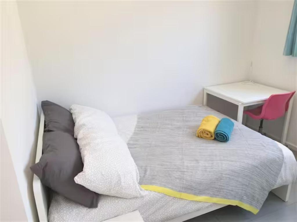 a bedroom with a bed with a yellow backpack on it at Private Room in a Shared House-Close to City & ANU-3 in Canberra