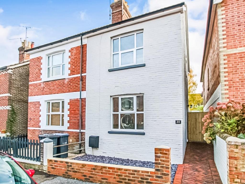 an exterior view of a white brick house at Sahara Rose in East Grinstead