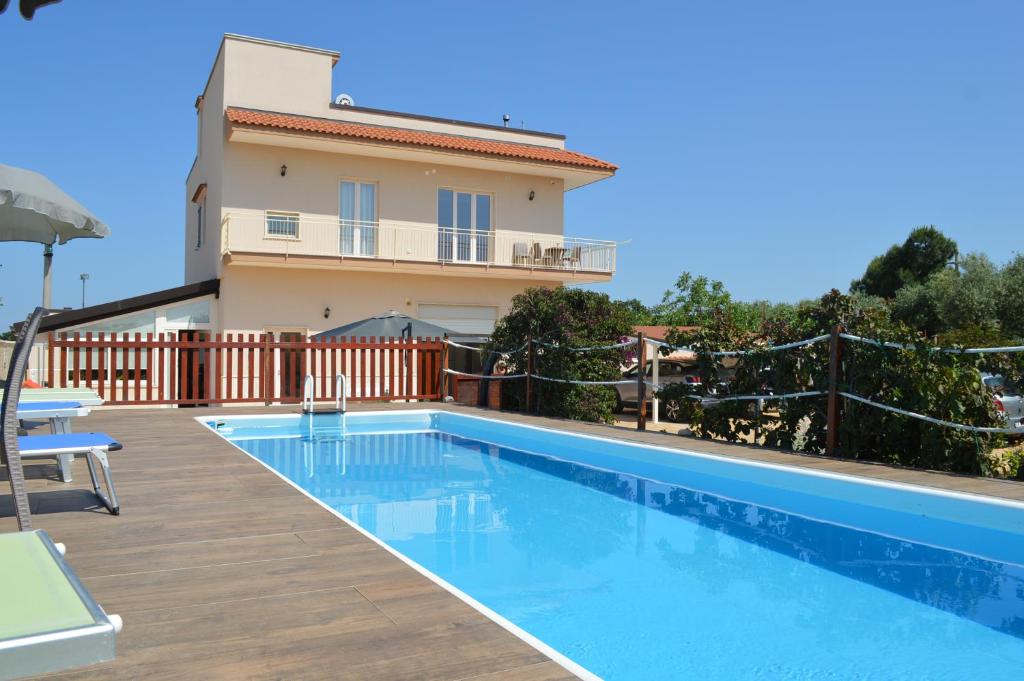 a swimming pool in front of a house at Villa Dario in Castellana Grotte