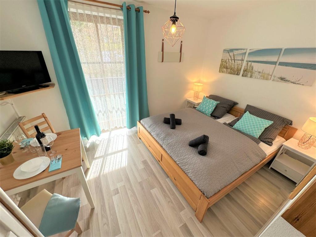 a bedroom with a large bed and a living room at COZY Apartment Bavarian Forest +POOL +SAUNA +NETFLIX in Zwiesel