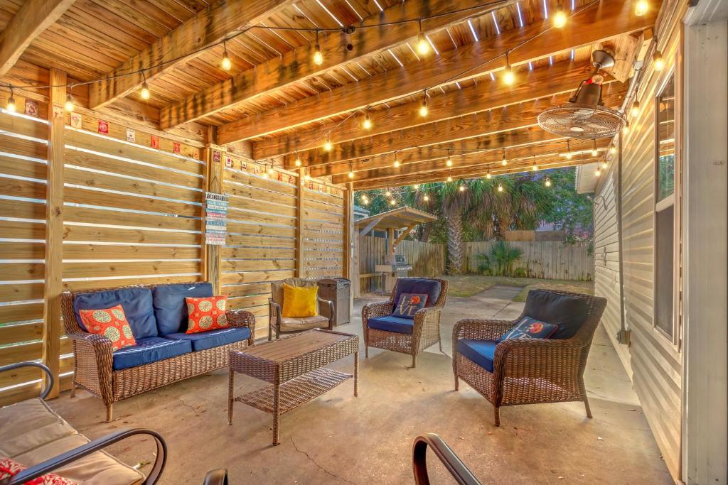 a patio with chairs and a couch and a table at Seaside Serenity at Shiplap Shack, Updated Coastal Beach Home w Beach Gear and Idyllic Outdoor Living, Just Steps from the Shore in Panama City Beach