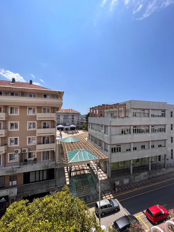 arial view of a building with a pool and a parking lot at Mint Apartment in Tivat