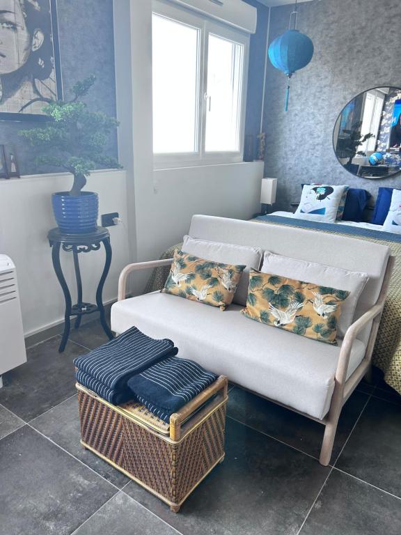 una sala de estar con un sofá y una cama en LE GEISHA, en La Grande-Motte