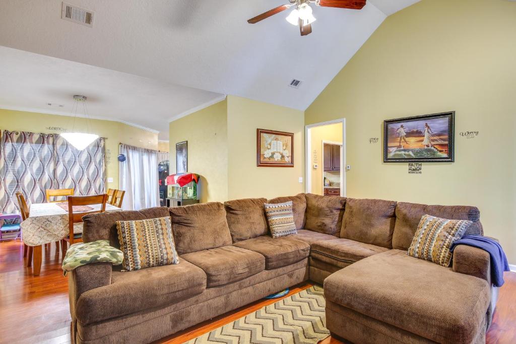 a living room with a brown couch and a table at Georgia Vacation Rental 14 Mi to Downtown Augusta in Hephzibah