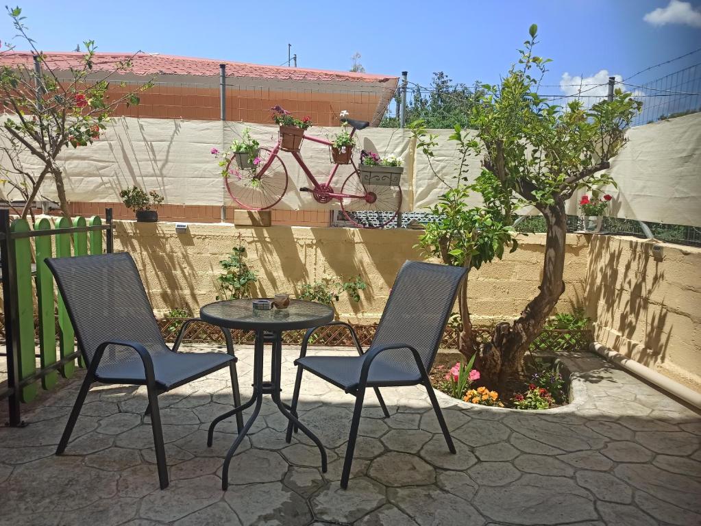 a patio with a table and two chairs and a bike at Alex Downtown Studio in Argostoli