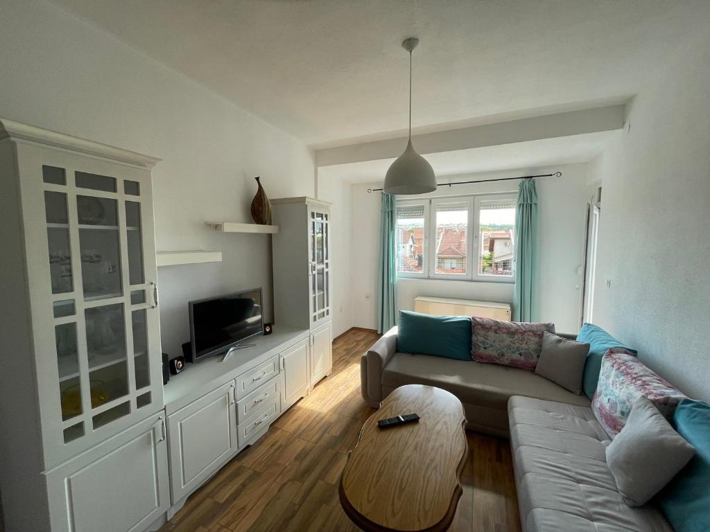 a living room with a couch and a table at ZOJA Apartments in Kavadarci