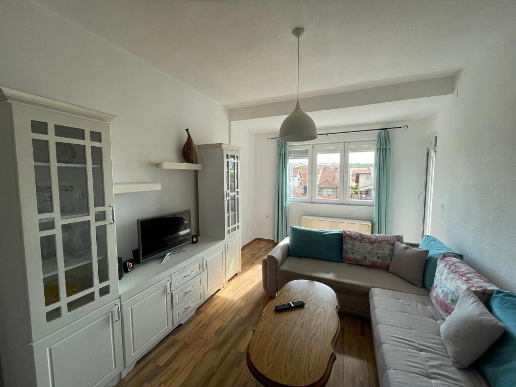 a living room with a couch and a table at ZOJA City Centre Apartments in Kavadarci