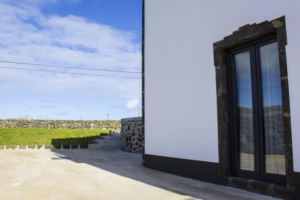 a building with a window on the side of it at Casa Lagar de Pedra T3 in Santa Cruz da Graciosa