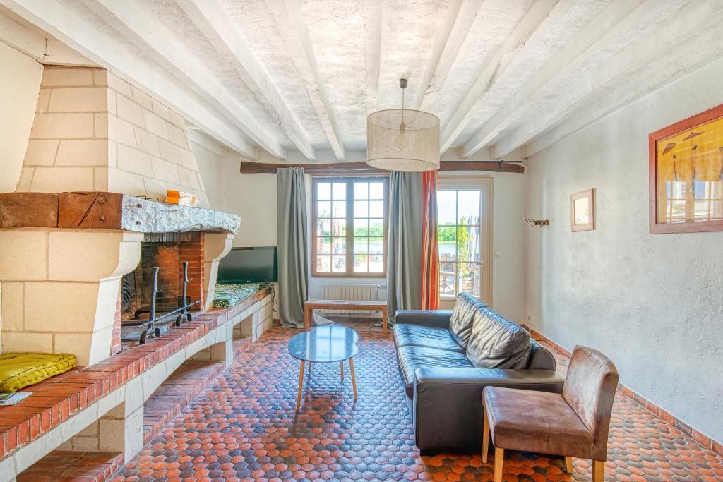 a living room with a couch and a fireplace at Gîte Monkey cottage in Bouchemaine
