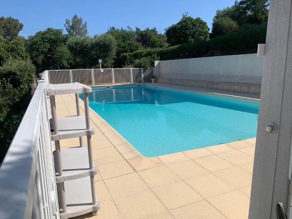 a ladder sitting next to a swimming pool at A 10mn de la plage!! in Cavalaire-sur-Mer
