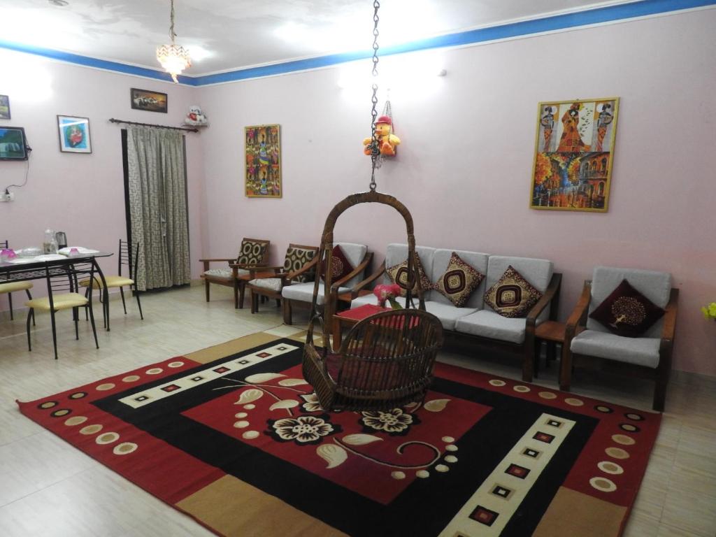 a living room with a couch and a table at Shanthi Villa in Coonoor