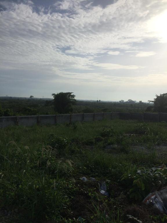 a field of grass with a fence in the distance at Mavern House Apartments in Elmina