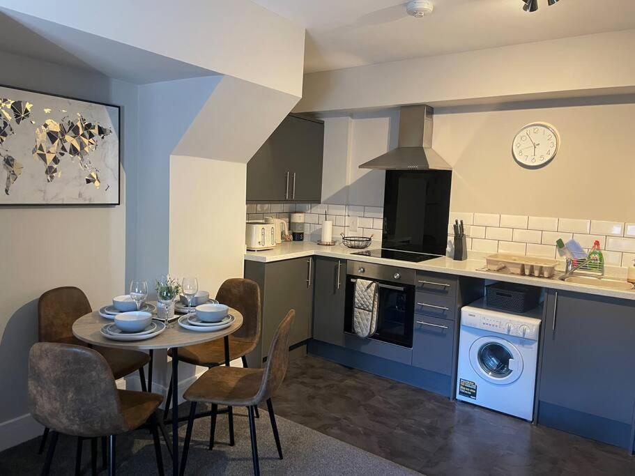 a kitchen with a table and chairs in a kitchen at Poplar House-2Bedroom house in town centre with free Parking by ShortStays4U in King's Lynn