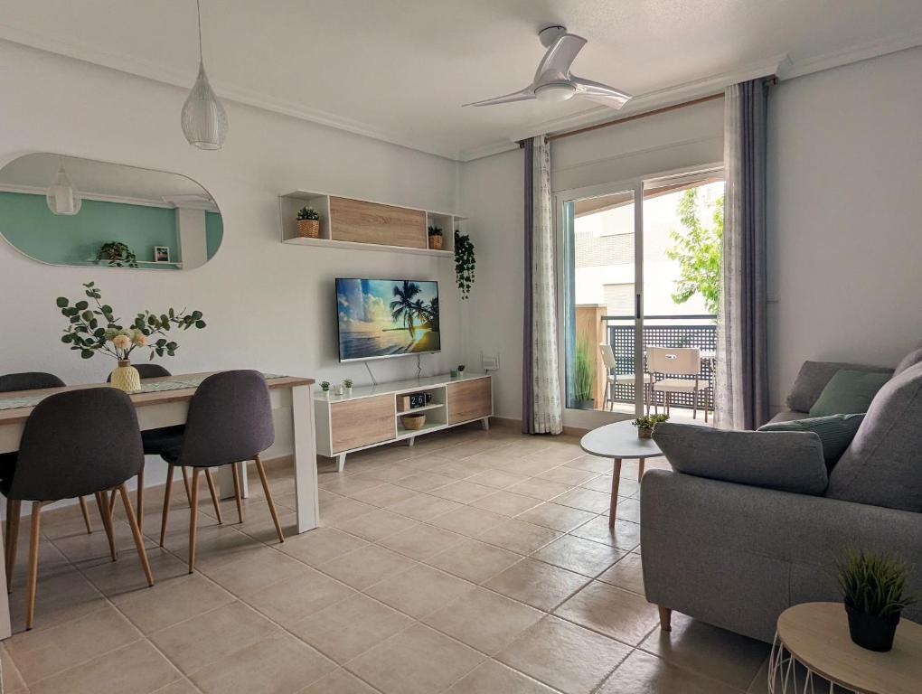 a living room with a couch and a table at Apartamento Las Palmeras - Con Terraza, barbacoa, aire acondicionado y a 250m de la playa! in Los Alcázares