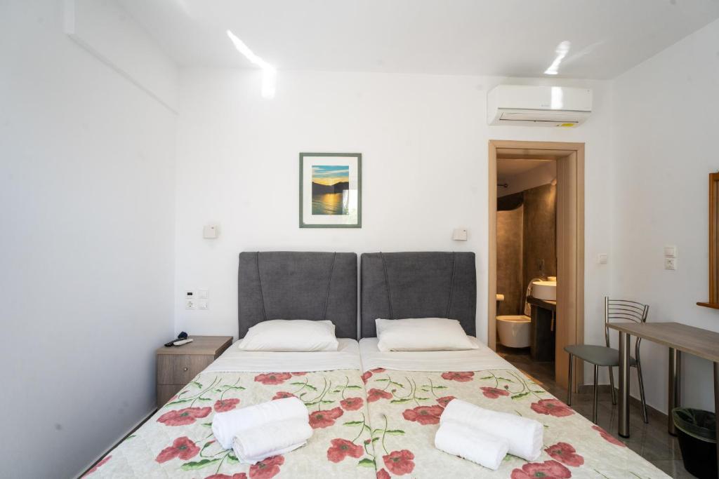 a bedroom with a large bed with two pillows at Liana Studios in Mýkonos City