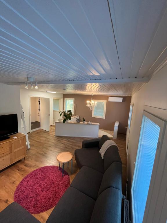 a living room with a couch and a table at Big Duplex, 15min to Turku or Naantali in Turku
