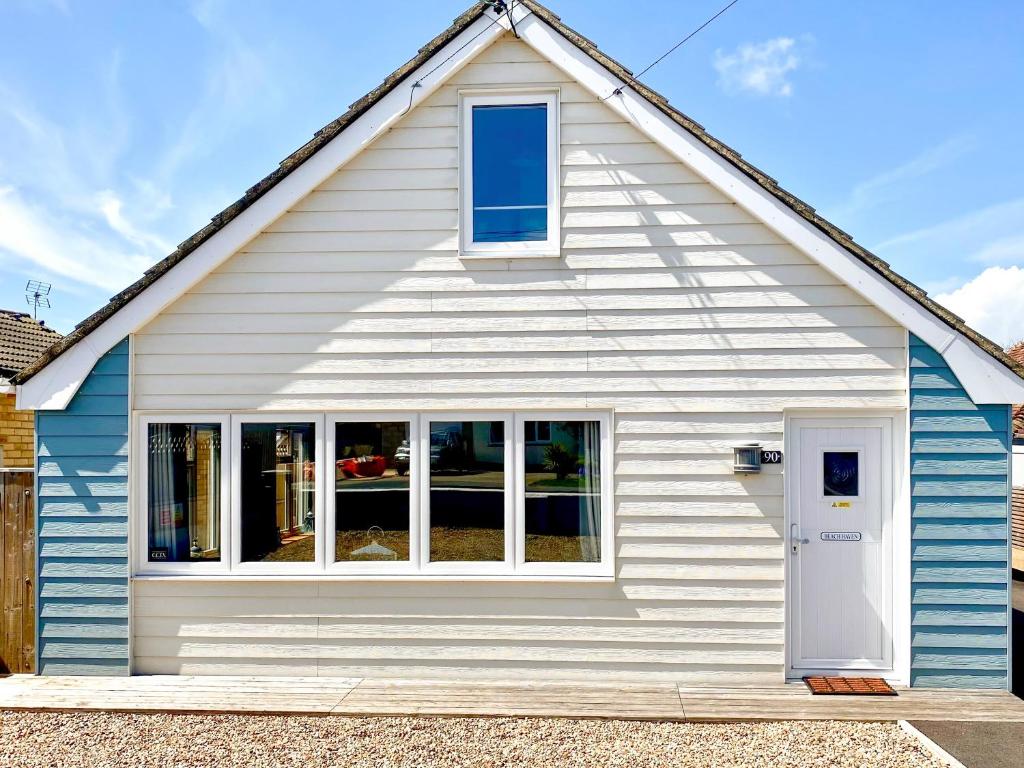 a blue and white house with a window at Beach Haven - Uk42241 in Littlestone-on-Sea