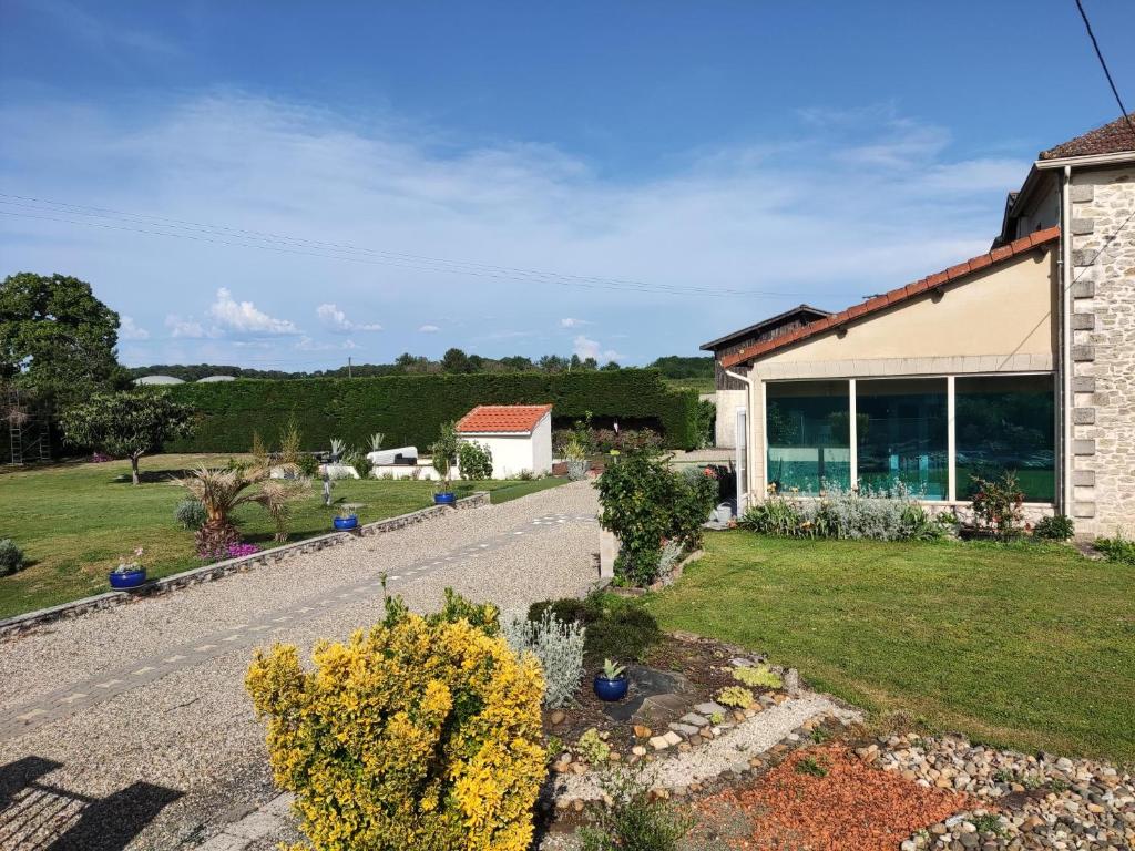 a house with a garden and a driveway at Les Bibasses in Aillas