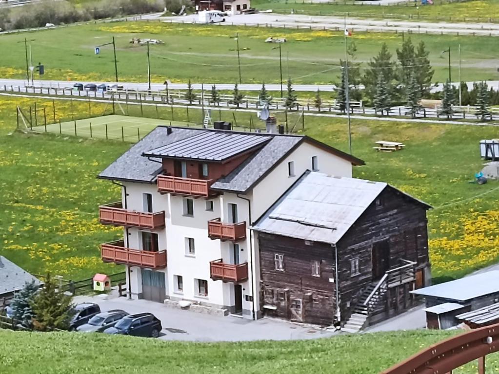 an aerial view of a building in a field at Wood Apartments in Livigno