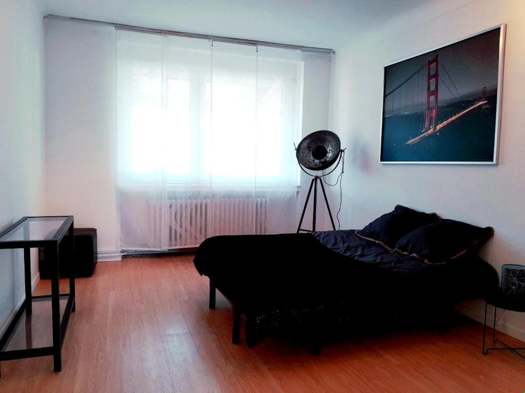 a bedroom with a bed and a window and a fan at Eden in Créhange