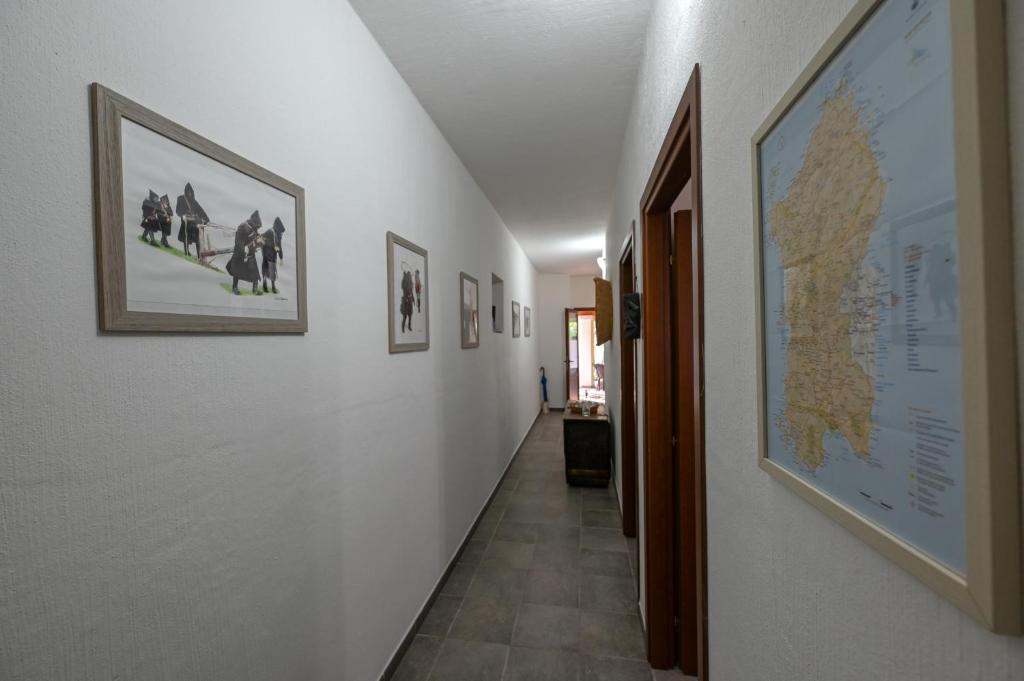 a hallway with pictures on the walls and a hallway with at B&B Su Neulagi in Triei