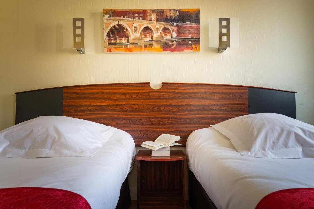 Postel nebo postele na pokoji v ubytování Hôtel Icare