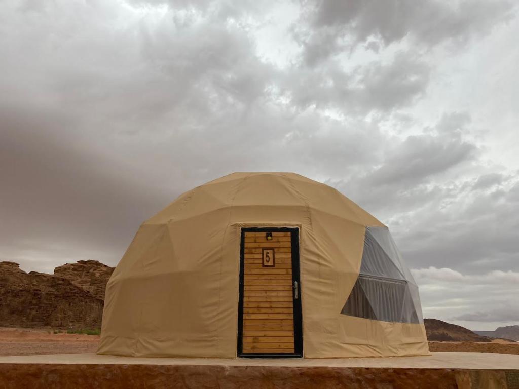 a large tent with a door in the desert at Al Rifi Luxury Camp in Wadi Rum