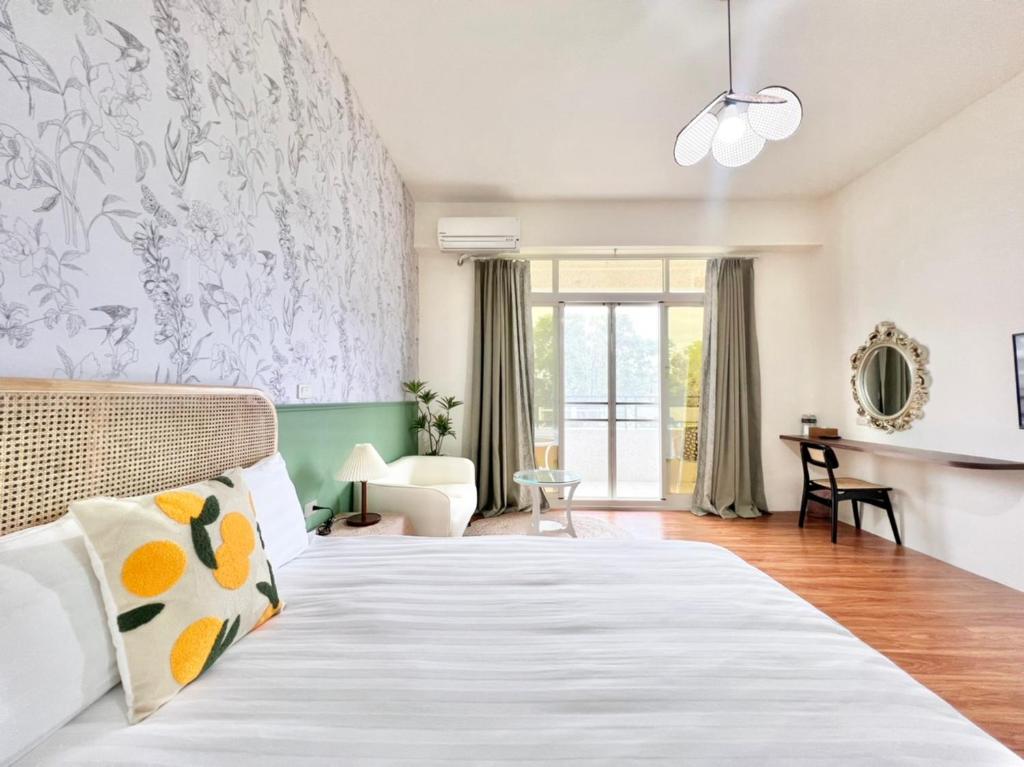 a bedroom with a bed and a living room at 永安101 Wing on x 附陽台 in Taitung City
