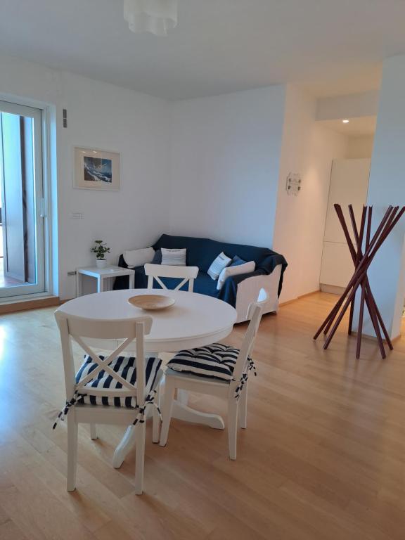 a living room with a table and chairs and a couch at Attico Suite spiaggia Bari in Bari